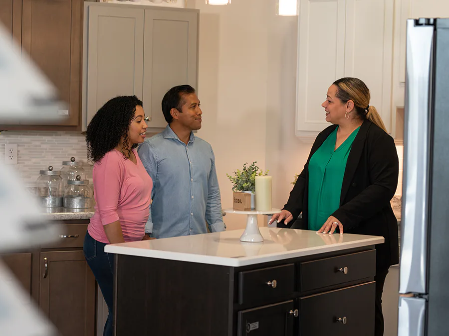 A designer at the Highland Homes Personal Selection Studio helping homebuyers design their dream kitchen